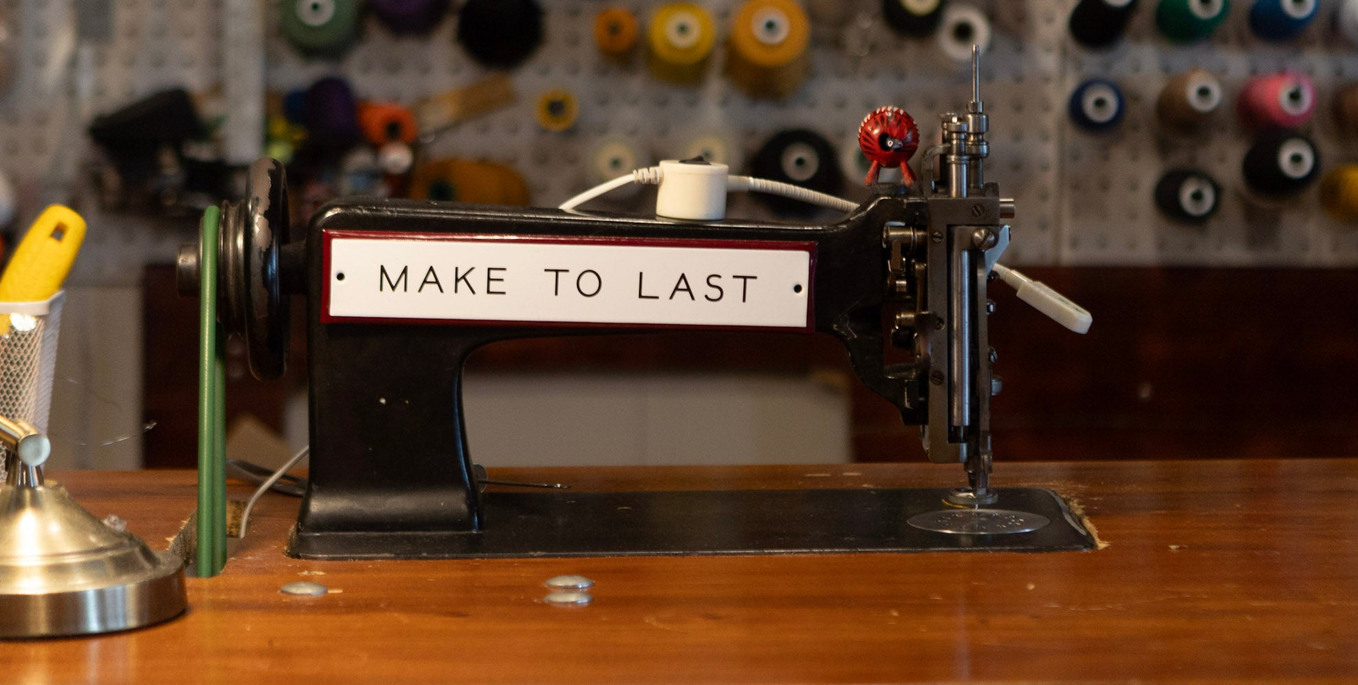 A Freehand Chainstitch Machine with thread in the background